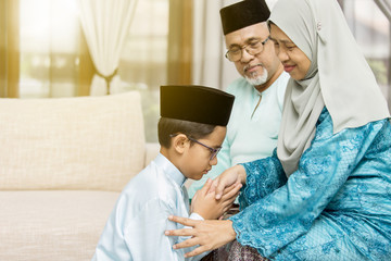 Traditional act of respect in Muslim family on Eid al-Fitr