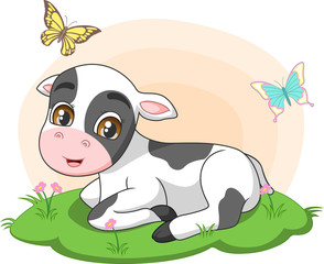 Cute little cow sitting in the grass