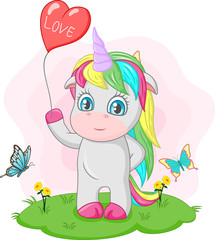 Cute baby unicorn holding red heart balloon in the grass