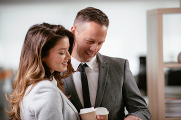 Colleagues in office. Businesswoman and businessman discussing work in office