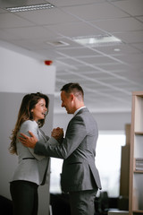 Colleagues in office. Businesswoman and businessman handshake in office.	