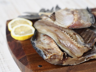 Fish background.Carcasses of freshly salted Russian river fish, ready to eat, on the kitchen cutting Board on a white wooden table.