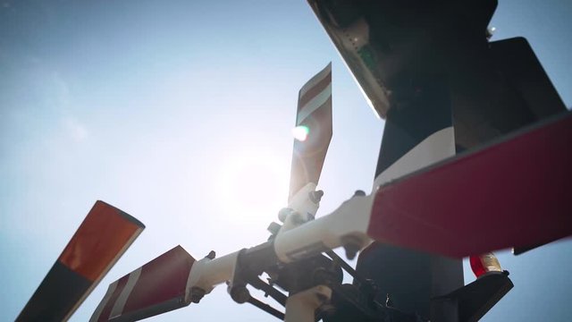 Helicopter tail rotor orbit with sun flare in slow motion