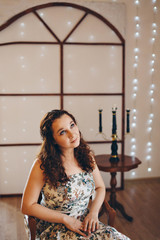 Fototapeta premium the girl is sitting on the chairs. spending time in self-isolation. interior decoration