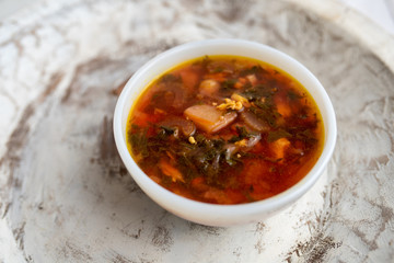 Russian borscht with sorrel and fresh garlic knots pamopushkas. hot soup with egg version. Sorrel soup. 