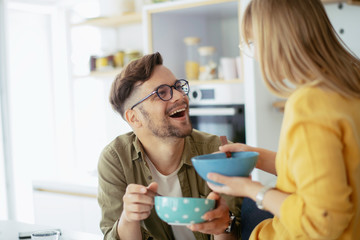 Young couple making breakfast at home. Loving couple enjoying in morning..