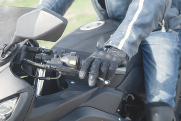 Caucasian motorcyclist with a black glove. Transport