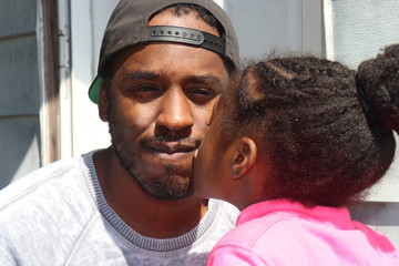 African American man with little girl outdoors