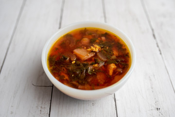 Russian borscht with sorrel and fresh garlic knots pamopushkas. hot soup with egg version. Sorrel soup. 