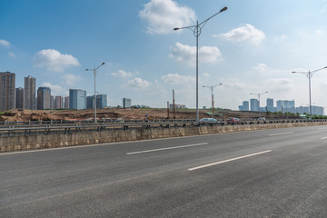 Asphalt road and city building landscape