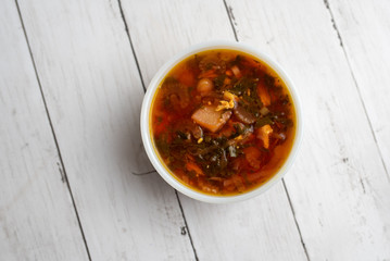 Russian borscht with sorrel and fresh garlic knots pamopushkas. hot soup with egg version. Sorrel soup. 