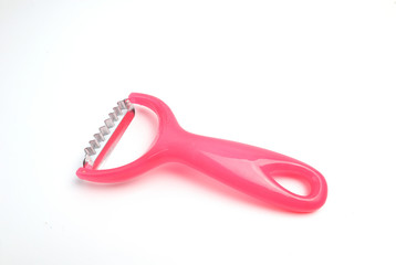 Pink fruit peeling device on a white ground