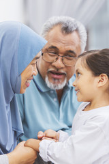 Grandparents spending time with their granddaughter