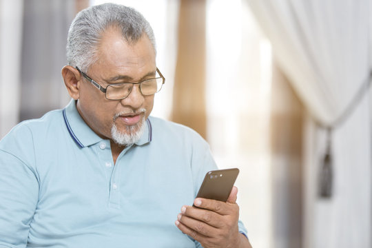 Senior Man Looking At His Phone