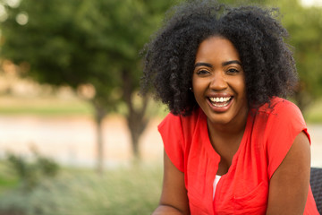 Fototapeta premium Happy confident African American woman smiling outside.