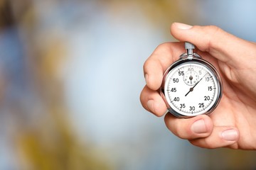 Silver classic stopwatch in the human hand