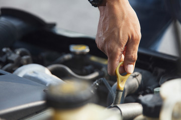 Man checking motor oil level