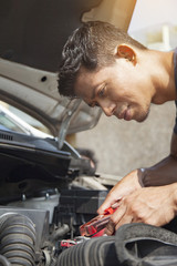 Man using battery jumper cables on a dead battery