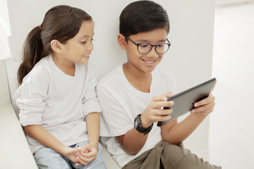 Brother and sister with a digital tablet