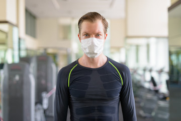 Young man with mask for protection from corona virus outbreak at gym during corona virus covid-19