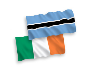 National vector fabric wave flags of Ireland and Botswana isolated on white background. 1 to 2 proportion.