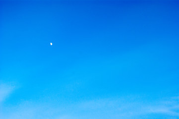 The growing moon or crescent moon is on a canvas of blue clear sky. Earth satellite, space.