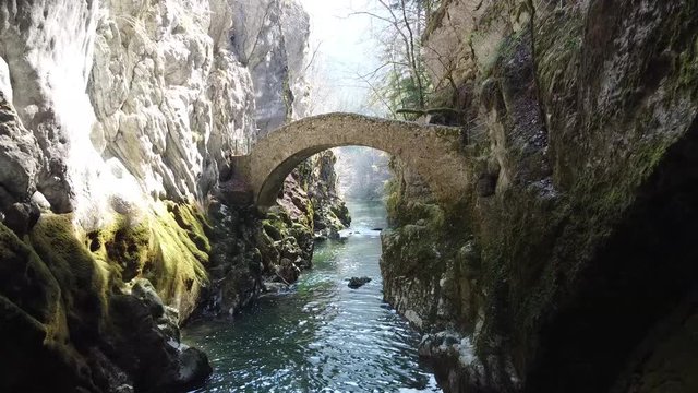 A drone inside the famous Swiss canyon called Areuse with nice bridge