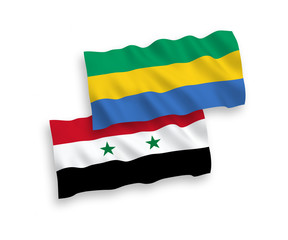 National vector fabric wave flags of Gabon and Syria isolated on white background. 1 to 2 proportion.