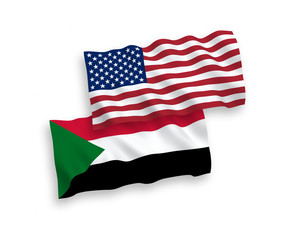 National vector fabric wave flags of Sudan and USA isolated on white background. 1 to 2 proportion.