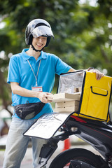 Food delivery man taking food from a bag
