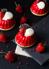 Blur picture of red Strawberry mouse cake  and macaroon on wood table black background. No focus.