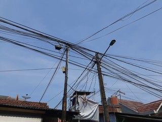 Electric cables on the roof of a house in Jakarta. household cables that are not neatly arranged.