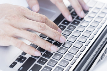 Fototapeta na wymiar Man typing on laptop keyboard