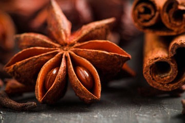 Anise stars and cinnamon sticks on the rustic wooden background. Selective focus. Shallow depth of field.