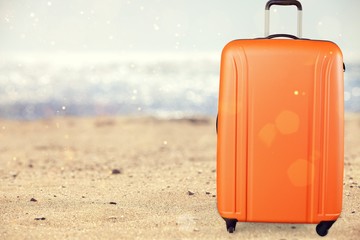 Beautiful colored suitcase on wheels for travel.