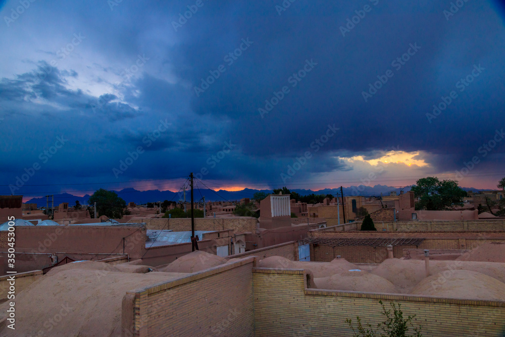 Wall mural ancient village in yazd-iran in a lovely day with beautiful and colorful sky and amazing sunset.