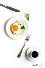 Fried eggs sandwich on plate - white dinner table top view