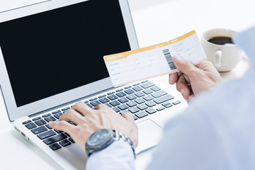 Man with boarding pass doing an online check in