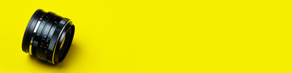 35mm camera lens in yellow background