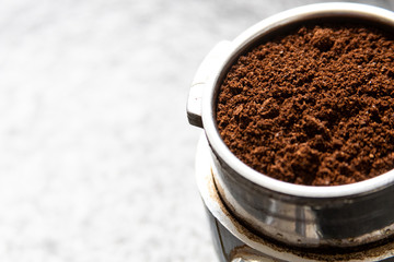 Filter holder for espresso coffee machine with coffee powder in detail. Italian espresso and fresh...
