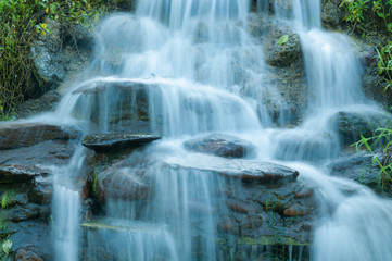 Closeup of small waterfall in the garden decorated