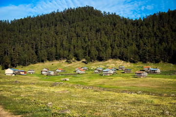 landscape with mountains, blue sky and village