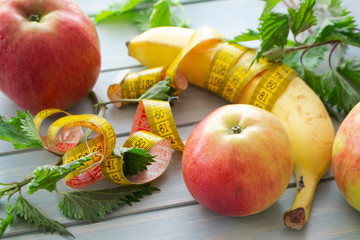 The dessert of fruit, green fresh nettle and centimeter close up on the table