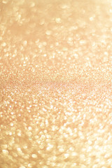 Sparkling bokeh background in a gold color. gold sequins background defocus