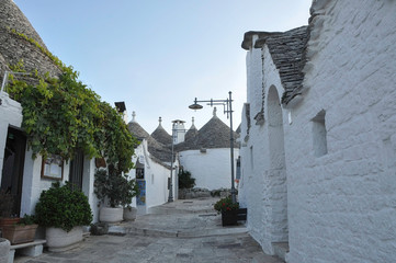 ALBEROBELLO, ITALY, EUROPE, AUTUMN 2019. Beautiful white street with trulli houses in the small...