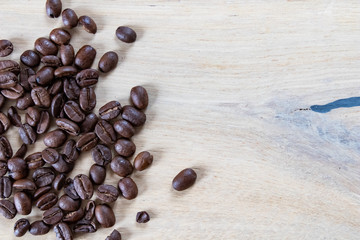 Coffee beans on wooden background, oak wood soft light and beans. Coffee background with wooden texture