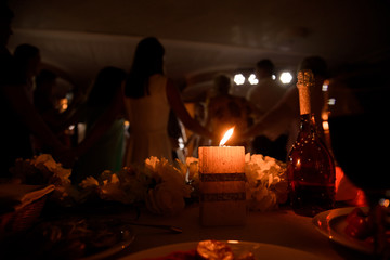 the candle is burning in the hands in the dark