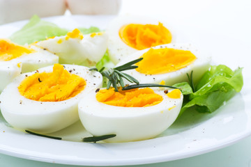 boiled eggs with salad leaves in a plate
