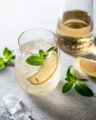 Cold drink. Lemonade with ice, lemon and mint in a glass.