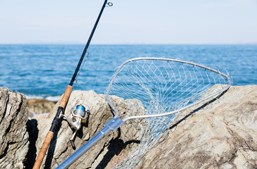 Fototapeta premium Spinning and fishing net on the rocks